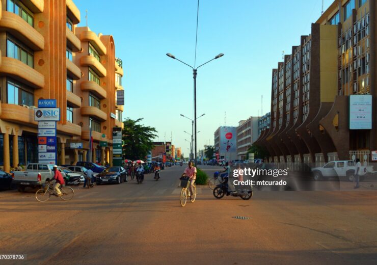 Ouagadougou, Burkina Faso: Kwame Nkrumah Avenue in Ouagadougou is a major thoroughfare in the capital of Burkina Faso, named in honor of Ghana's first president, a key figure in Africa's independence movements. The avenue is an important commercial and administrative center, with numerous businesses, hotels, and offices situated along its length. It plays a significant role in the daily economic activities of the city, serving as a focal point for local commerce and services. Its name reflects Burkina Faso's connection to broader pan-African ideals and the shared history of post-colonial African development. On the right the Ministry for Civil Service and Social Security and on the left the BSIC bank.
