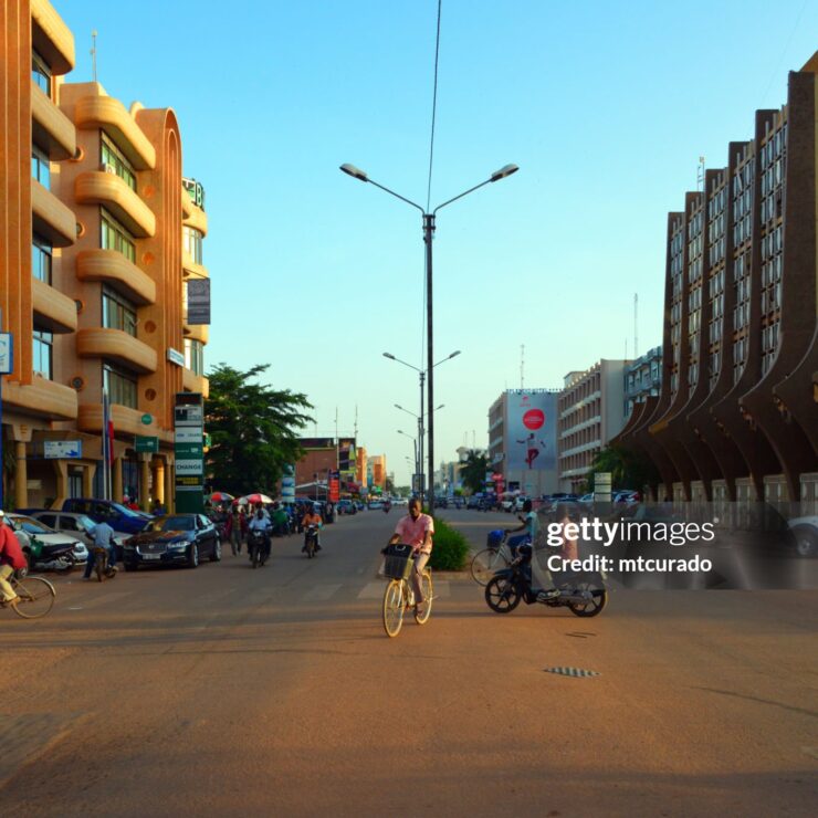 Ouagadougou, Burkina Faso: Kwame Nkrumah Avenue in Ouagadougou is a major thoroughfare in the capital of Burkina Faso, named in honor of Ghana's first president, a key figure in Africa's independence movements. The avenue is an important commercial and administrative center, with numerous businesses, hotels, and offices situated along its length. It plays a significant role in the daily economic activities of the city, serving as a focal point for local commerce and services. Its name reflects Burkina Faso's connection to broader pan-African ideals and the shared history of post-colonial African development. On the right the Ministry for Civil Service and Social Security and on the left the BSIC bank.