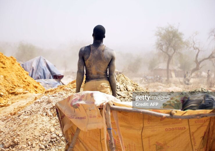 TO GO WITH STORY BY JORIS FIORITI
A miner stands of a clandestine gold mine on February 20, 2014 in the village of Nobsin, 10km from the city of Mogtedo in the Ganzourgou region, where the gold fever doesnt spare children who risk their lives trying to find a way to survive.  AFP PHOTO / AHMED OUOBA        (Photo credit should read AHMED OUOBA/AFP via Getty Images)